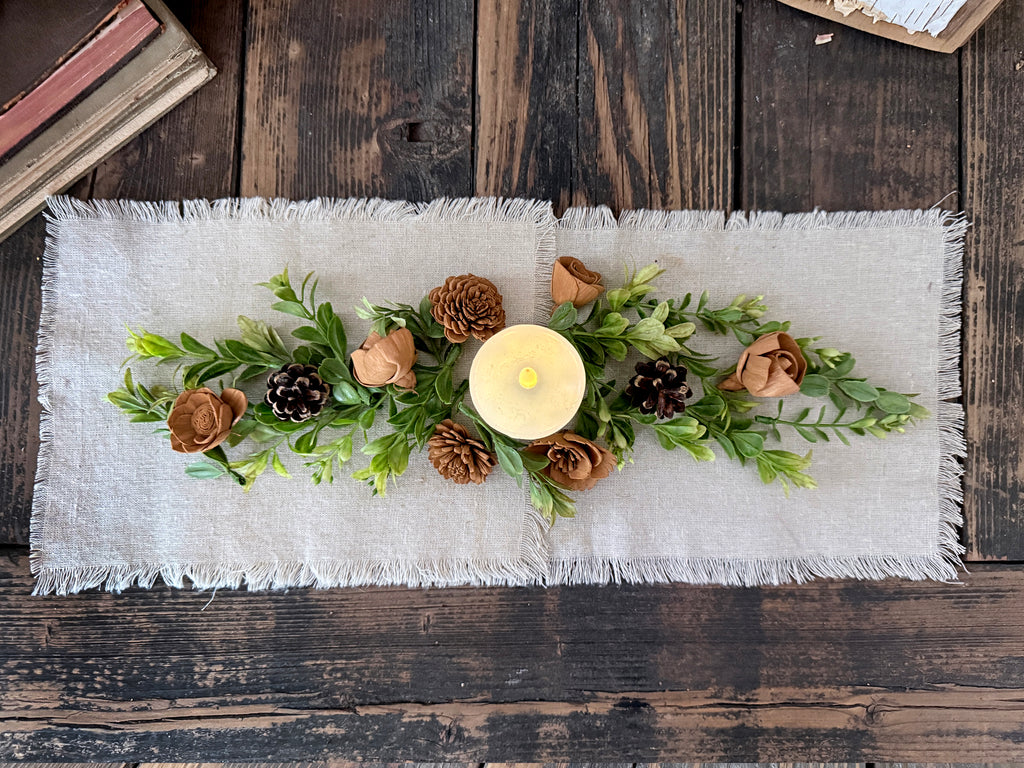 Boxwood greenery table runner decor with candle in the middle. 