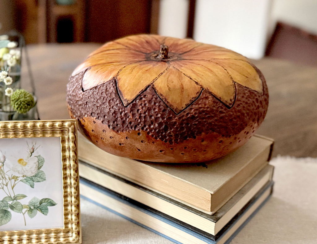 A hand carved gourd bowl with sunflower blossom fitted lid. Decorative bowl is stain a rich brown on the bottom and a hand painted sunflower lid.