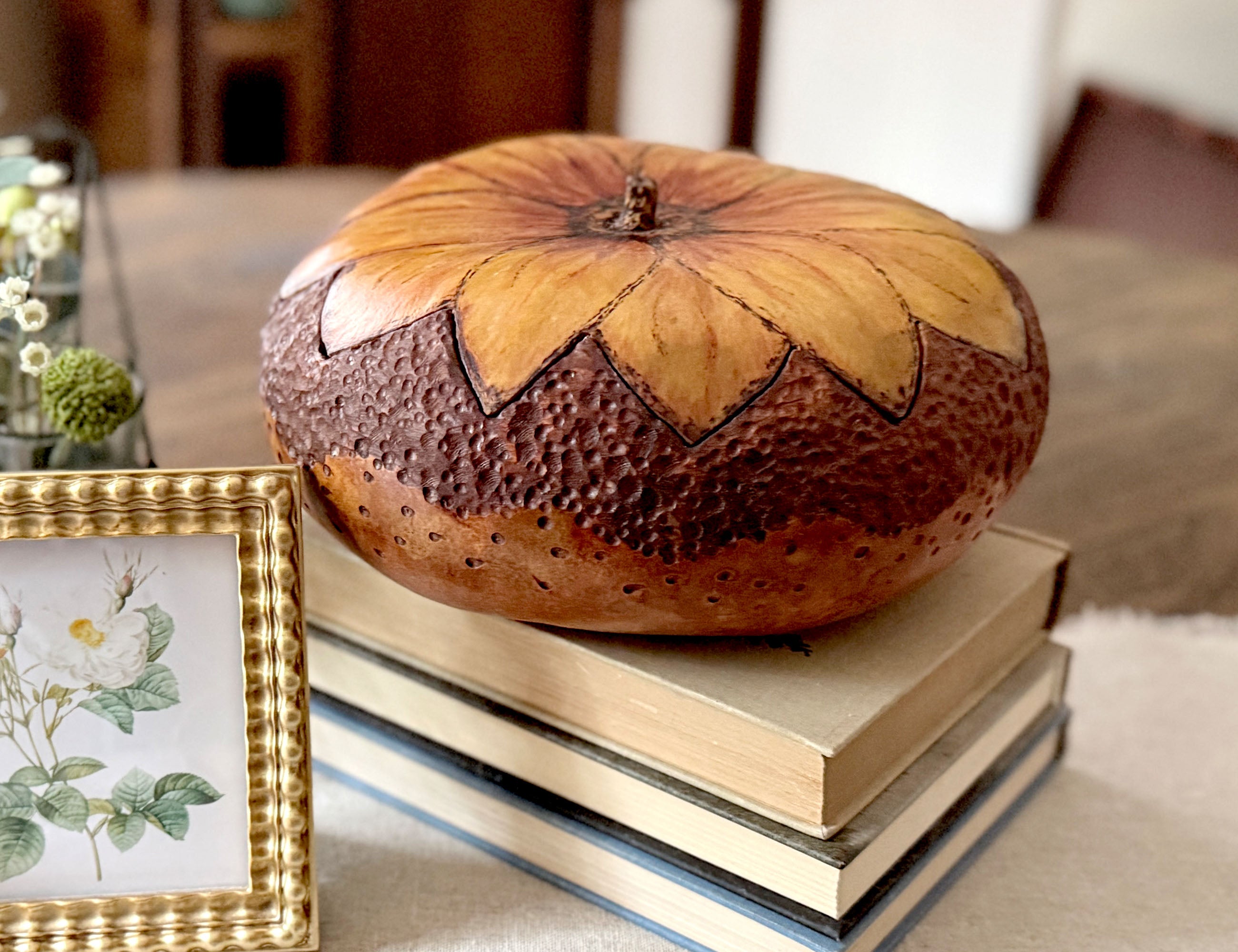 A hand carved gourd bowl with sunflower blossom fitted lid. Decorative bowl is stain a rich brown on the bottom and a hand painted sunflower lid.