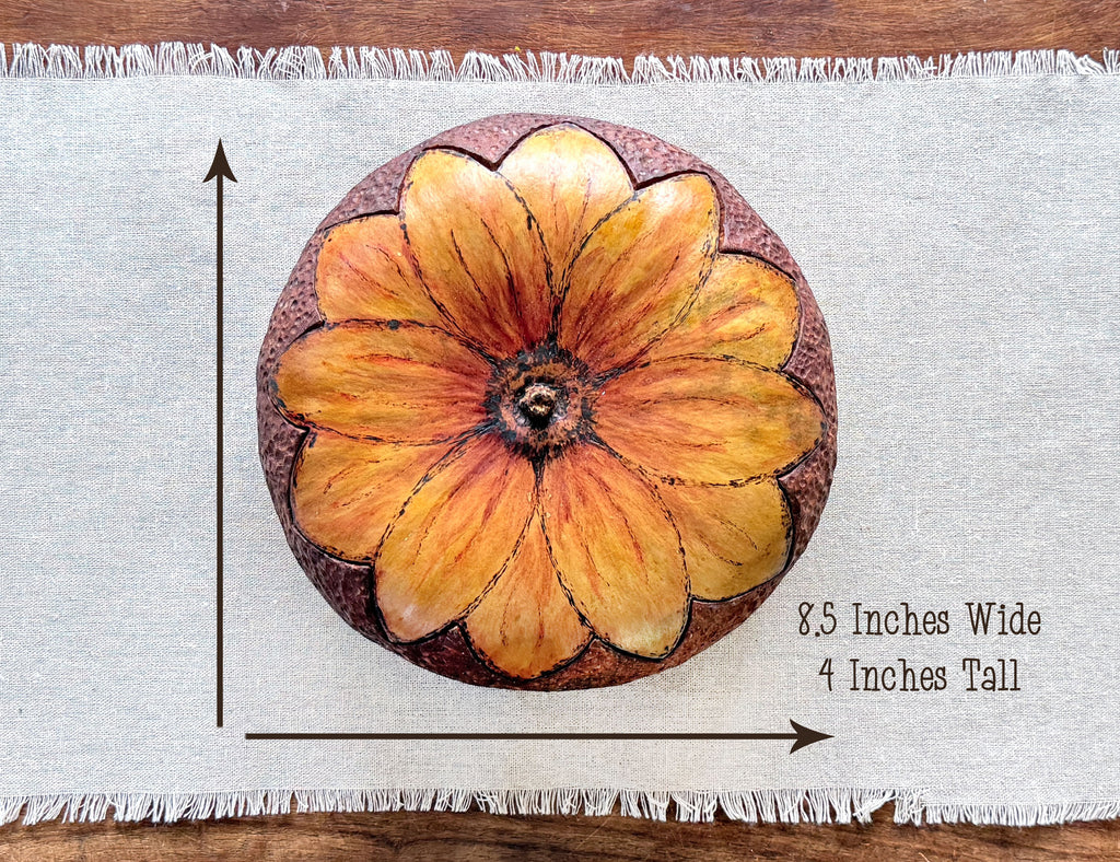 Top down view of a round gourd bowl with a sunflower shape blossom lid. Measurements are 8.5 by 4 inches.