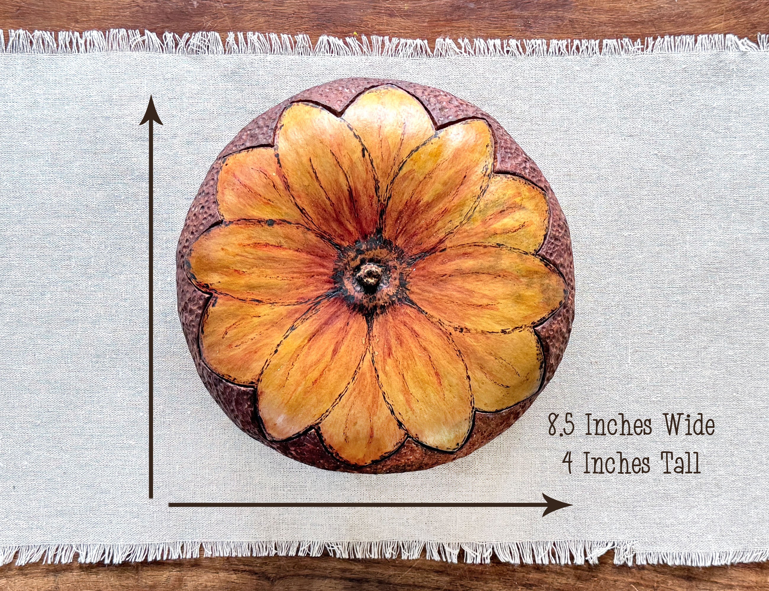 Top down view of a round gourd bowl with a sunflower shape blossom lid. Measurements are 8.5 by 4 inches.