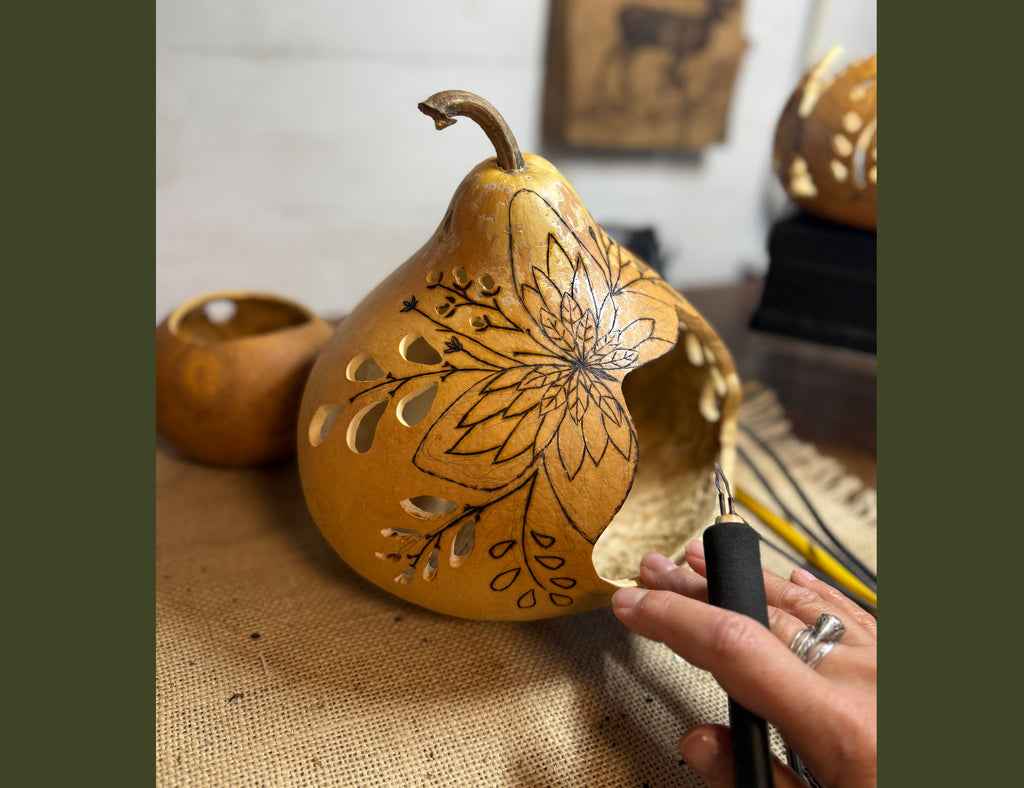 Gourd getting butterfly artwork burned into shell