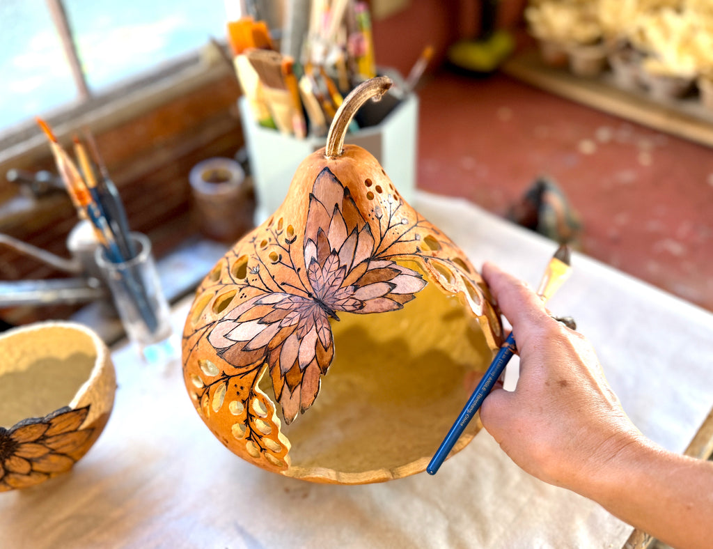 Butterfly gourd getting painted with translucent stains