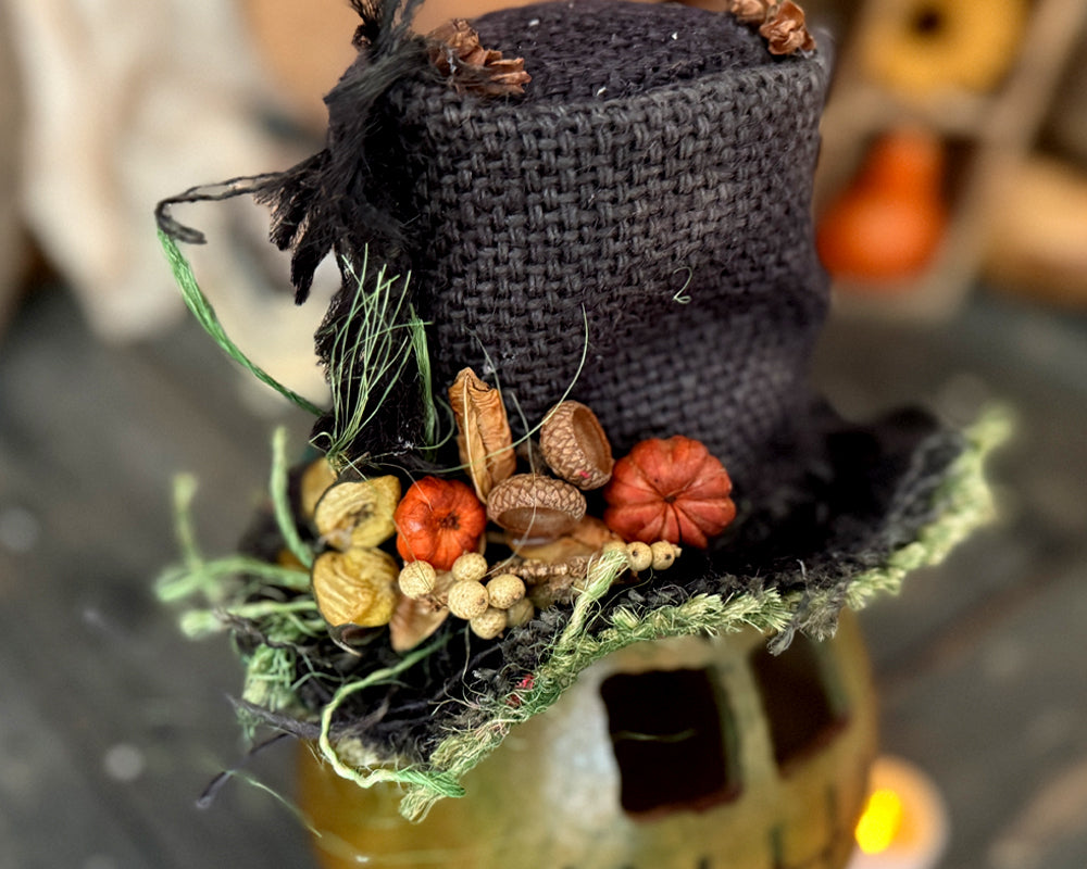 closeup of autumn details on brim of burlap top hat. 