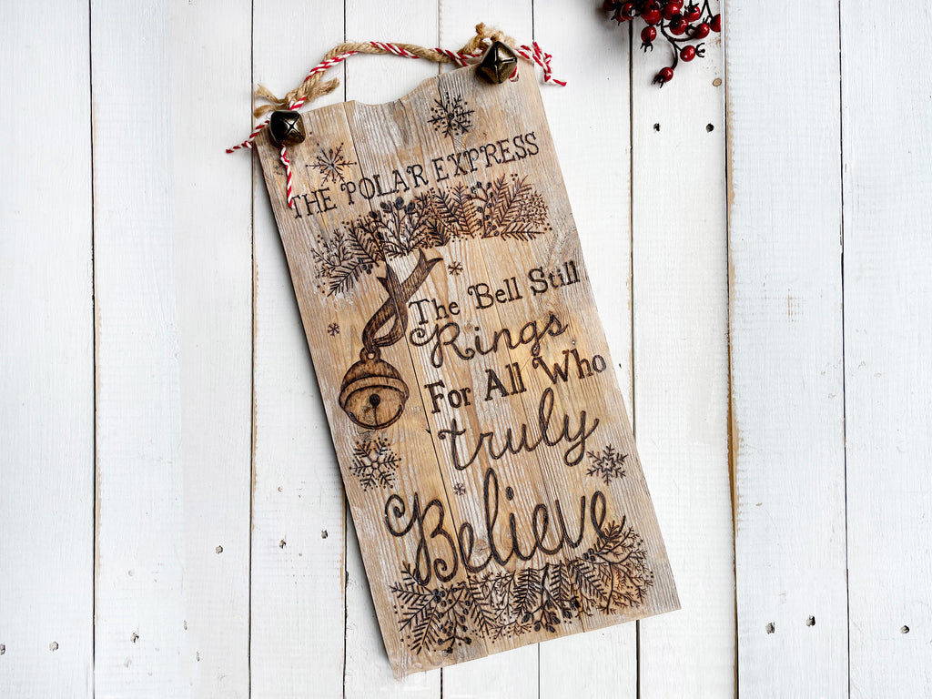 Wooden sign with 'The Polar Express' text and design on a white wooden background