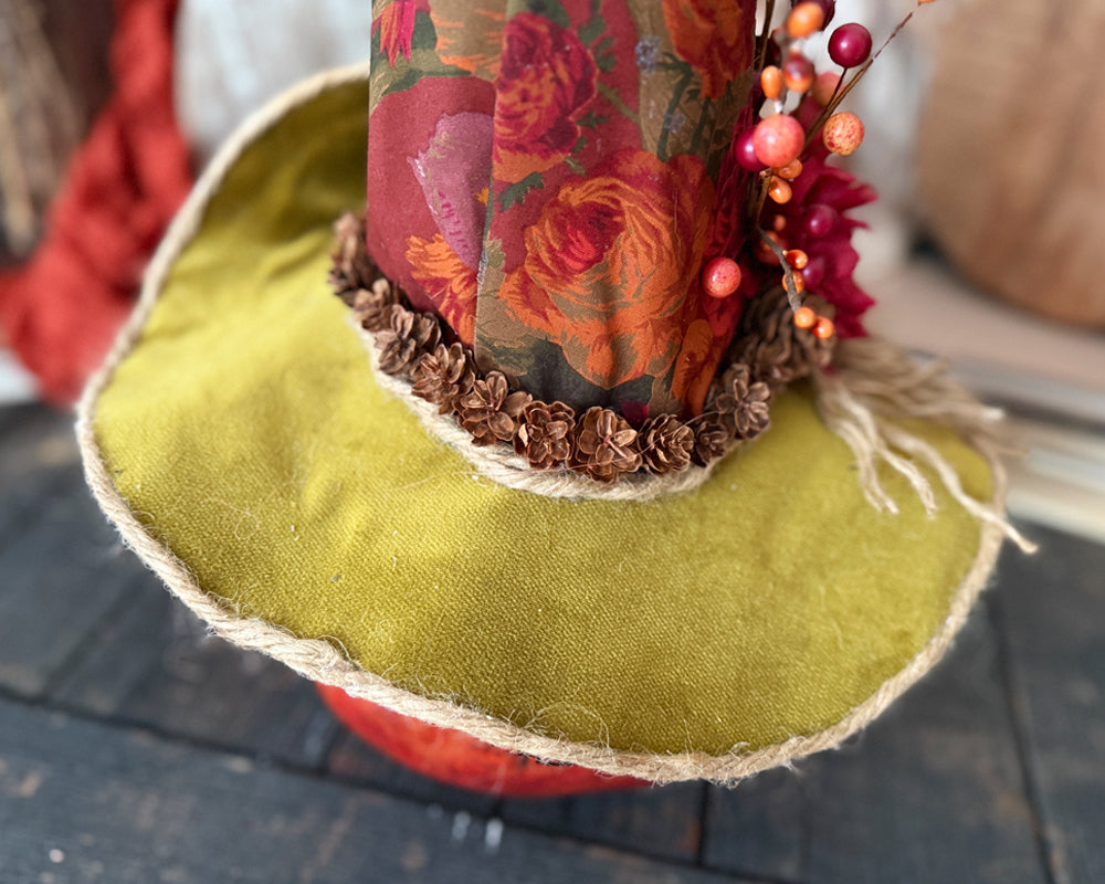 Close of of custom witch hat on pumpkin gourd. 