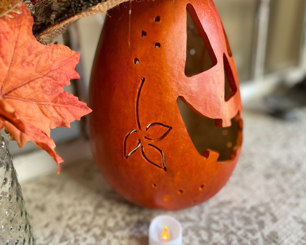 Decorative lantern with leaf patterns on a surface with a blurred background