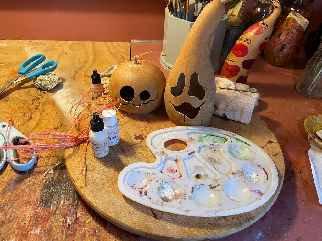 Two carved gourds get ready to be painted for Halloween
