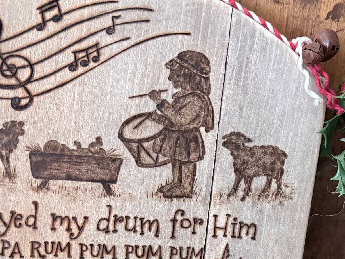 Close up image shows details of the little drummer boy silhouette artwork along with baby Jesus and sheep.