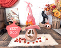 A pink ghost with a pink witch hat. This is a real dried gourd in a Halloween table display.