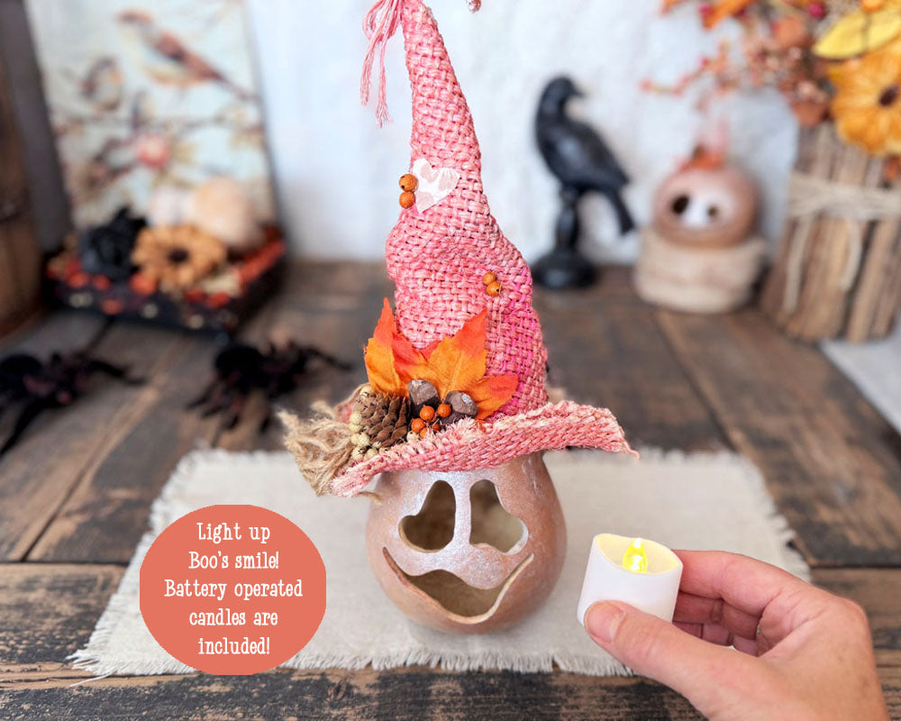 A hand hold the candle included with the purchase of this pink ghost