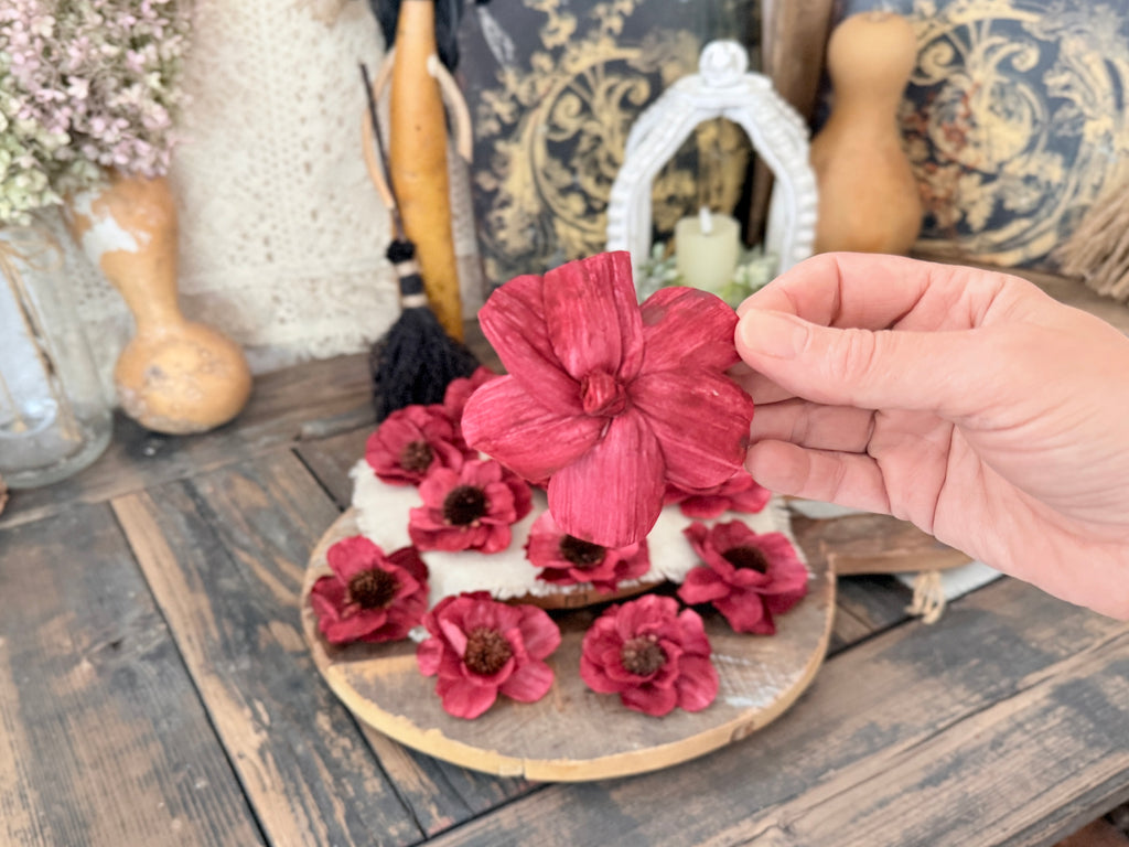 back view of with red flowers on a wooden surface