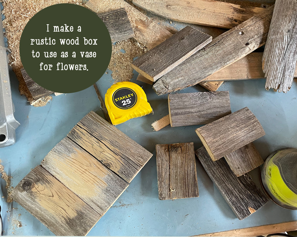 Wooden boards and a tape measure on a blue surface with text about making a rustic wood box.