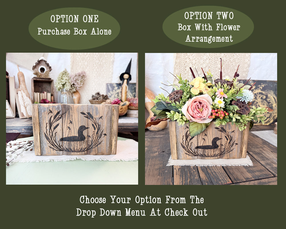 Two wooden boxes with floral arrangements on a wooden surface, one plain and one with flowers.