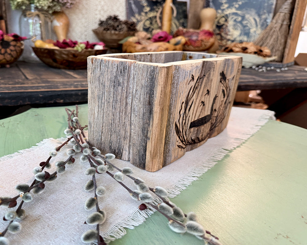 hand crafted Wooden vase with engraved design on a table with decorative elements