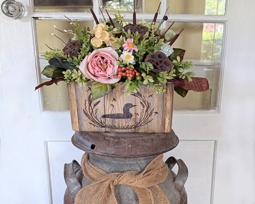 Lake life themed Floral arrangement in a wooden box with a duck design on a antique milk can