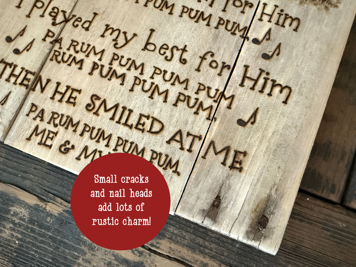 Close up image of Drummer boy sign shows wood details like old nail heads that are left in the wood 