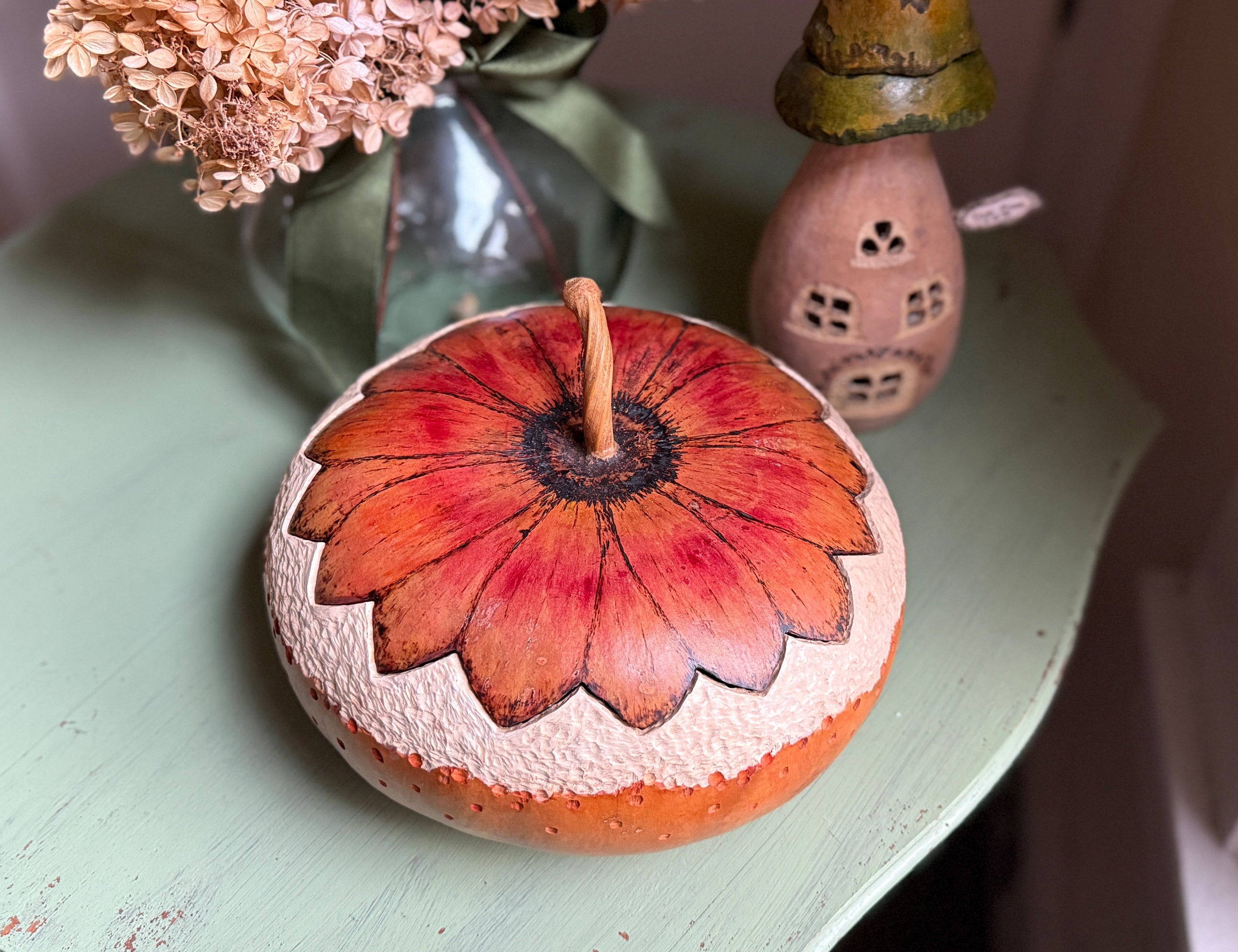 Decorative stone with floral design on a light green surface