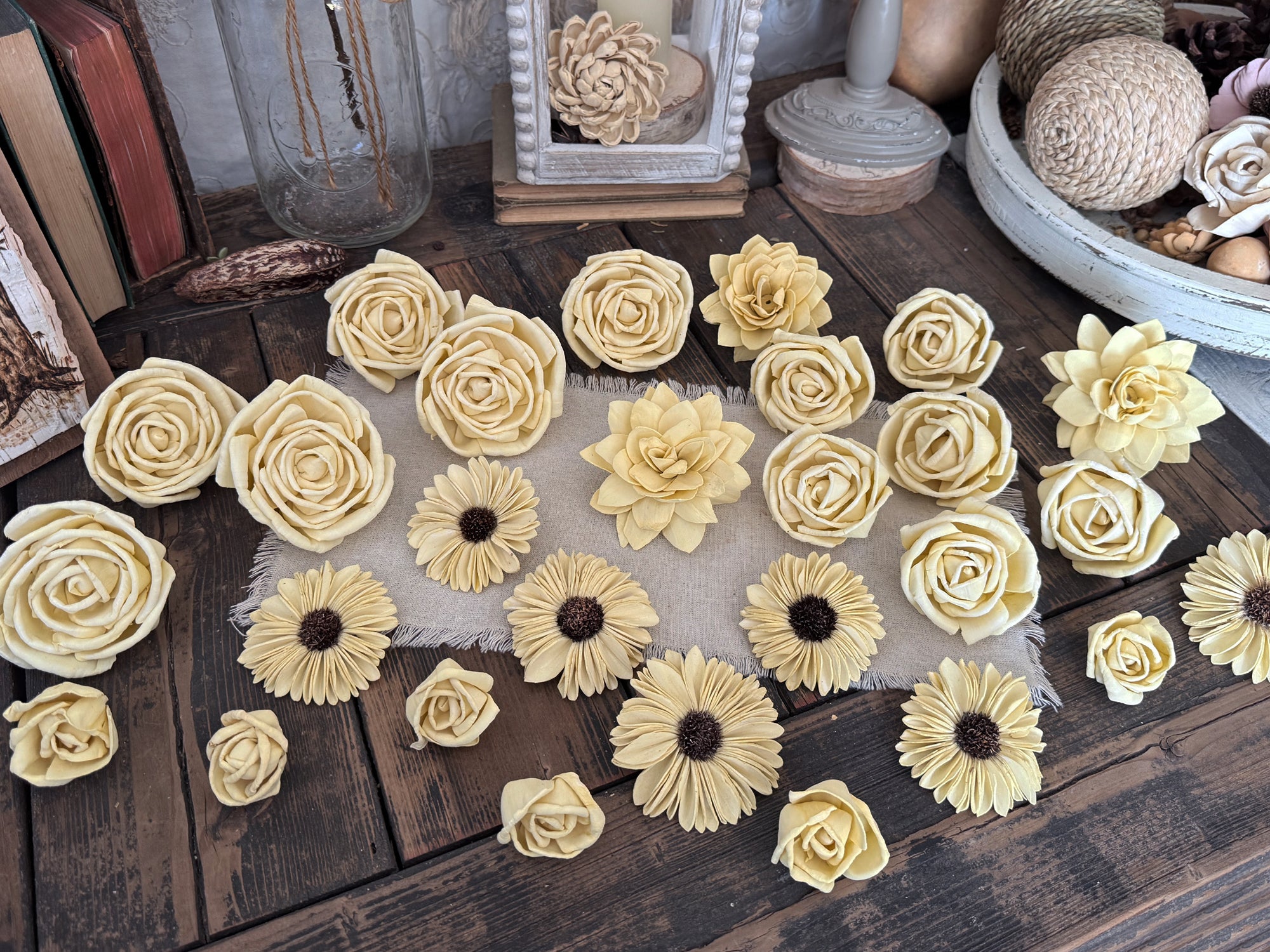 Collection of decorative yellow flowers on a wooden surface