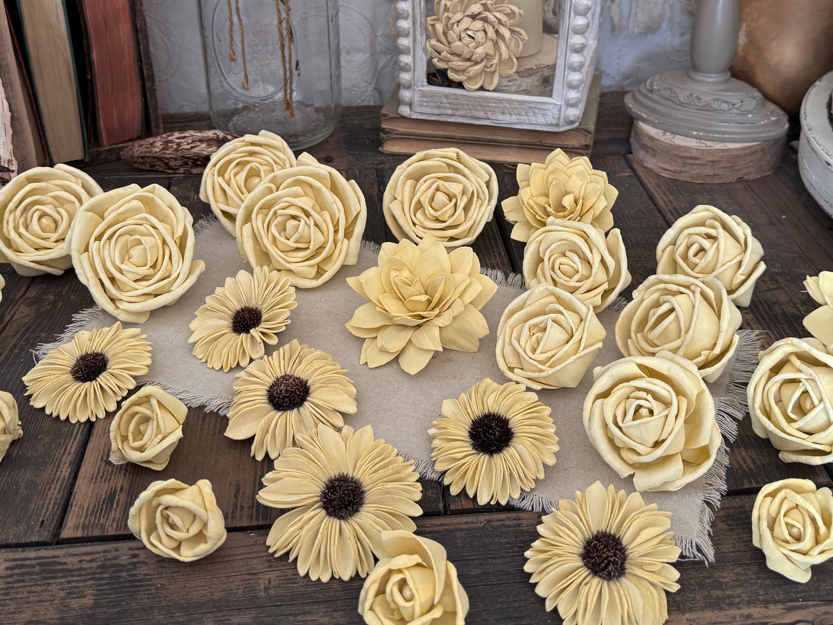 Decorative light yellow flower blossoms on a wooden surface with a rustic background.