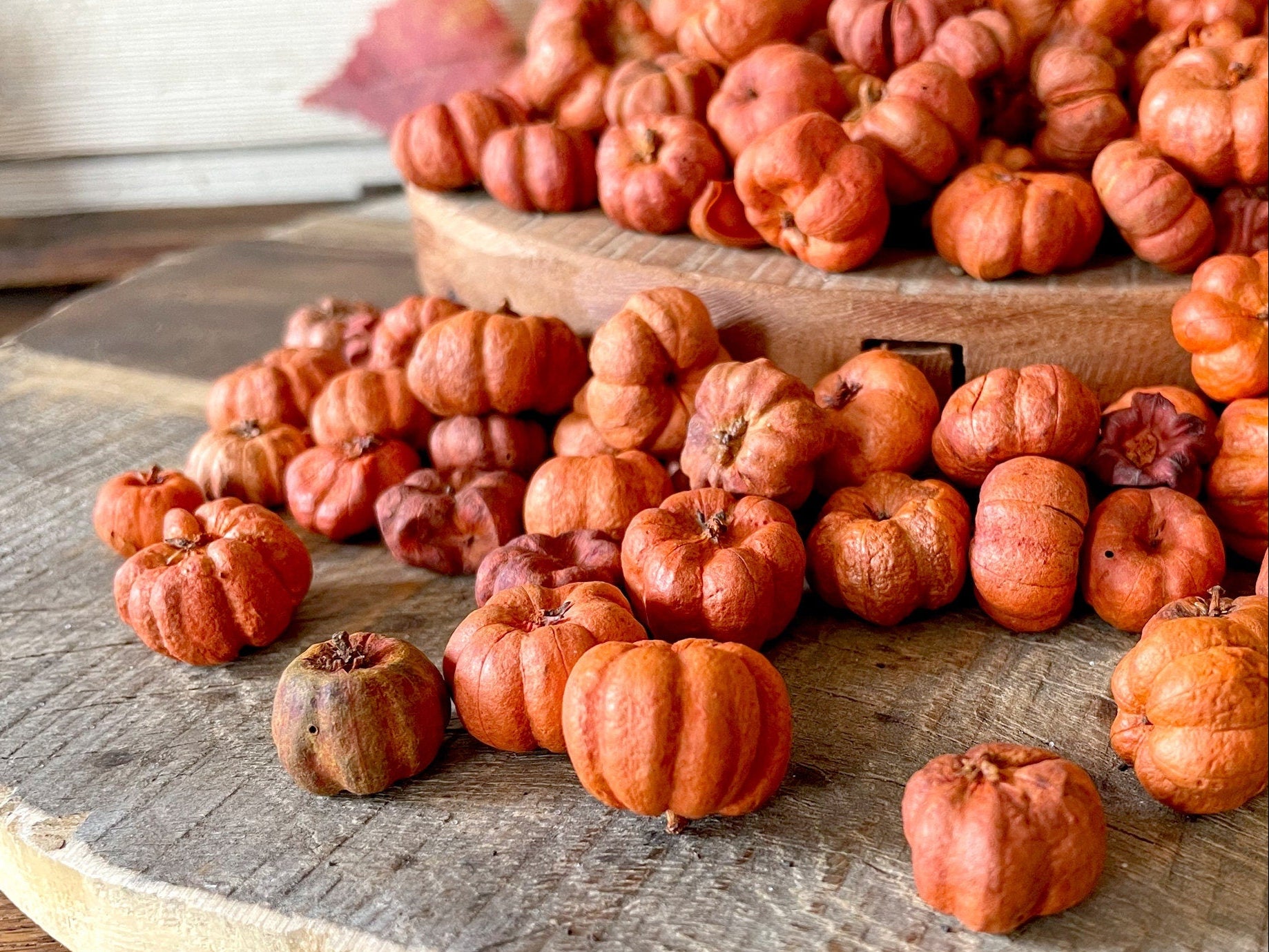Small pumpkins on a wooden surface with a rustic background