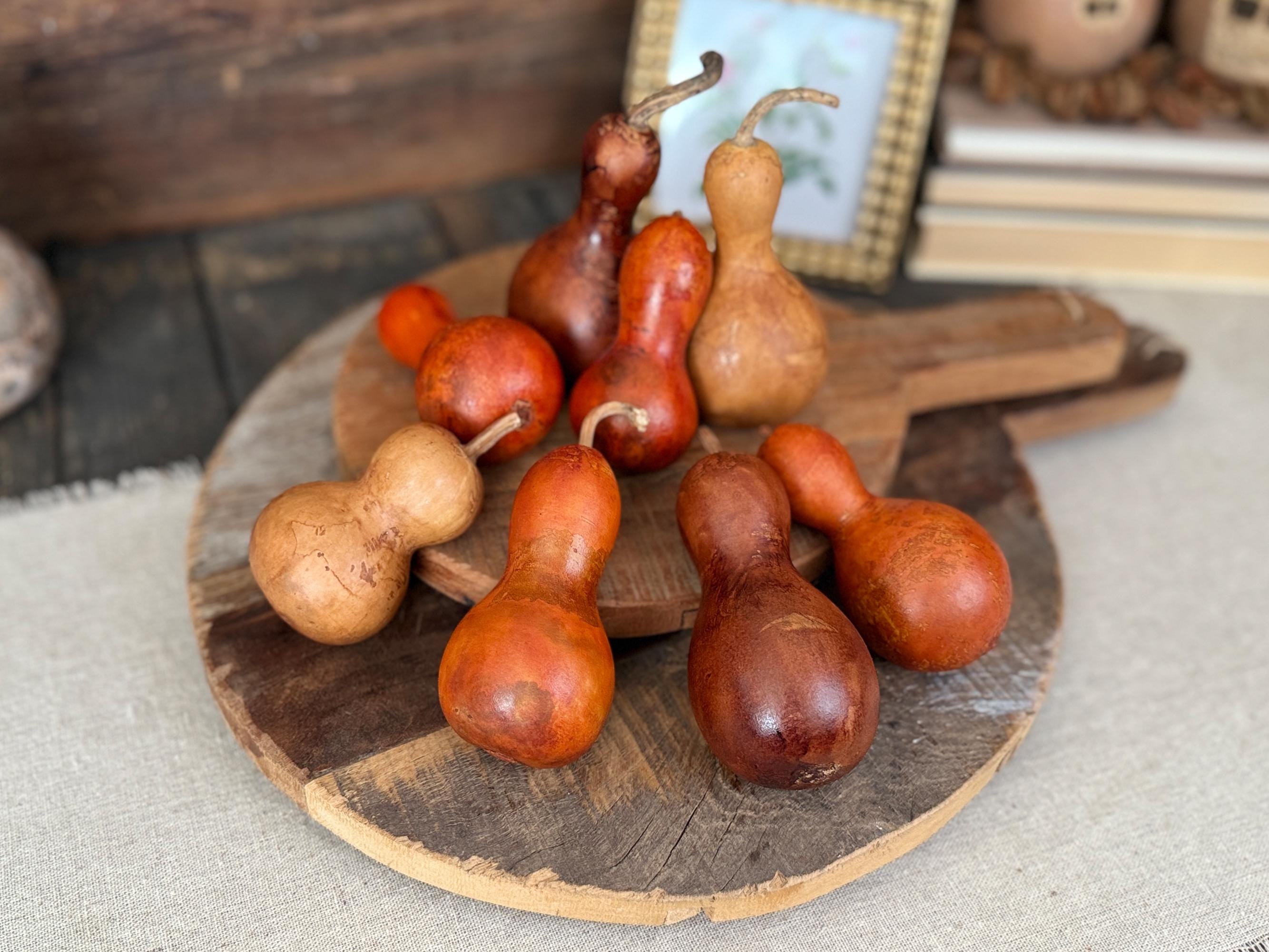 Decorative gourds on a wooden board with a rustic background