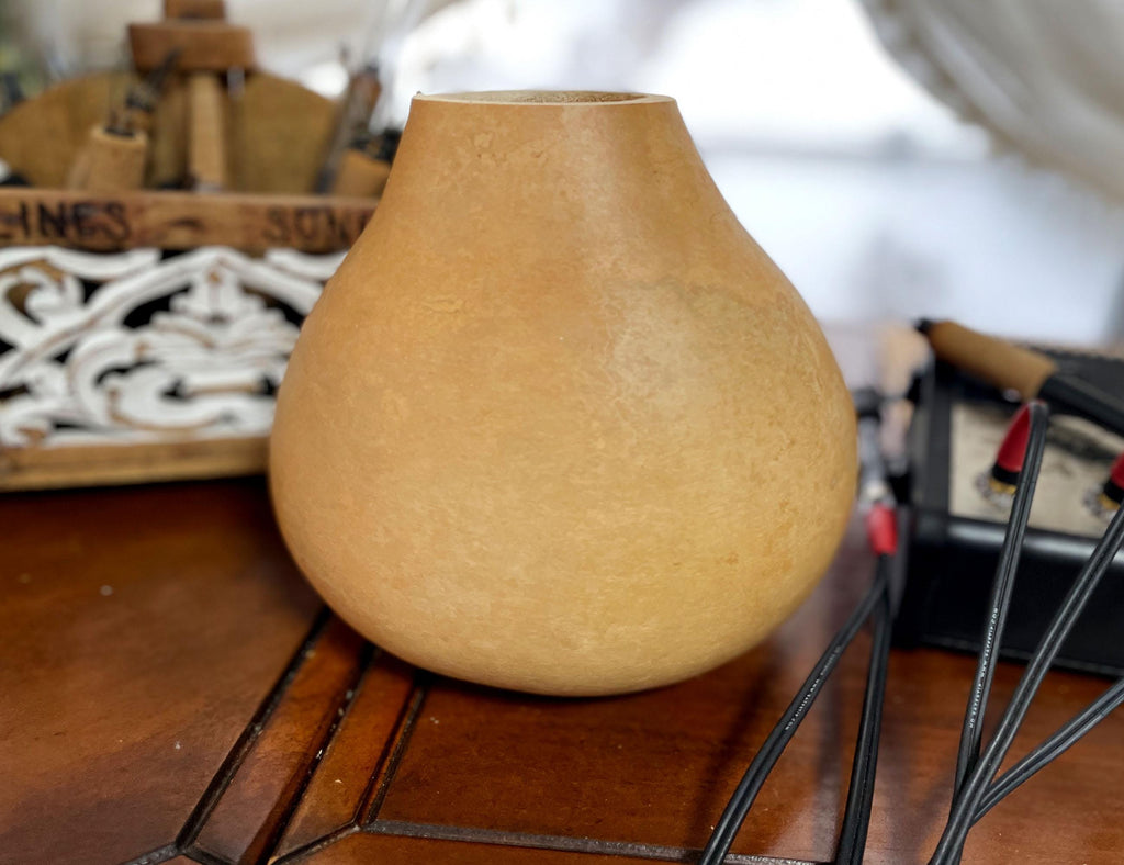 Beige gourd on a wooden surface with blurred background
