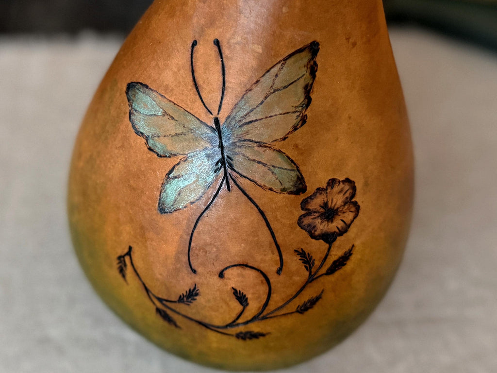 Gourd with a butterfly design on a neutral background