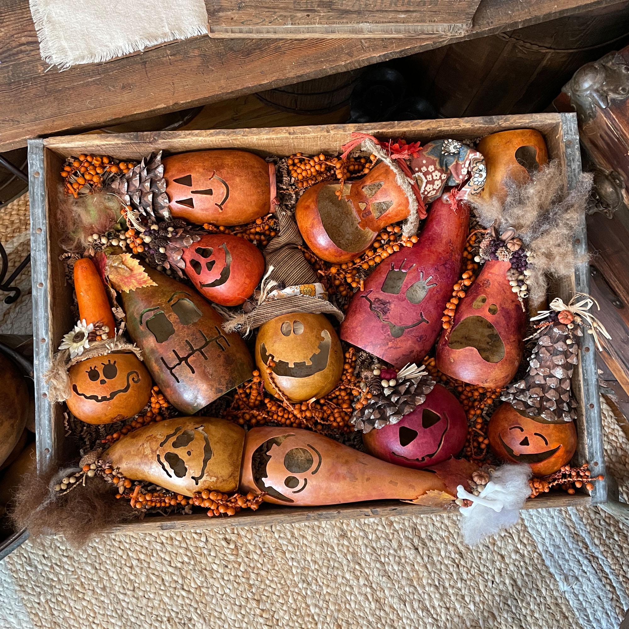 Decorative box with gourds and pumpkins on a rustic wooden surface