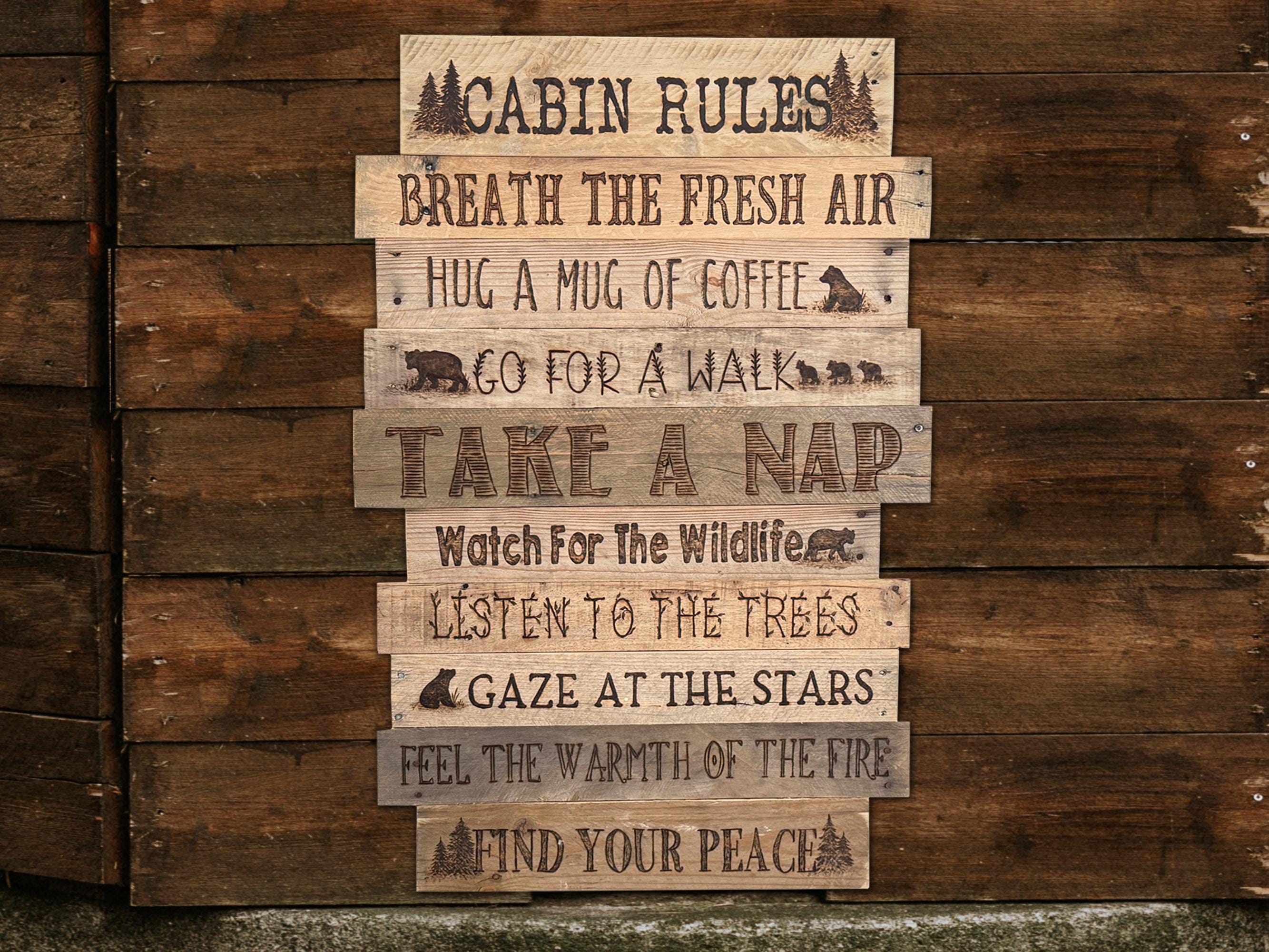 Wooden sign with 'Cabin Rules' on a wooden background