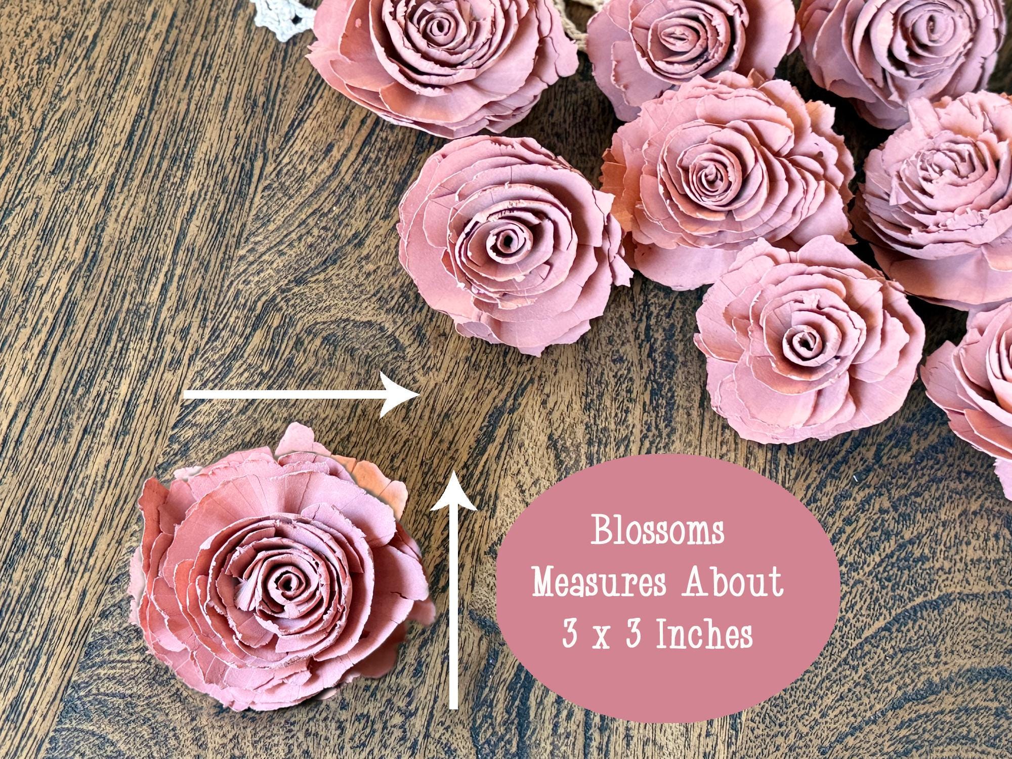 Pink wood floral blossoms on a wooden surface with measurement text.