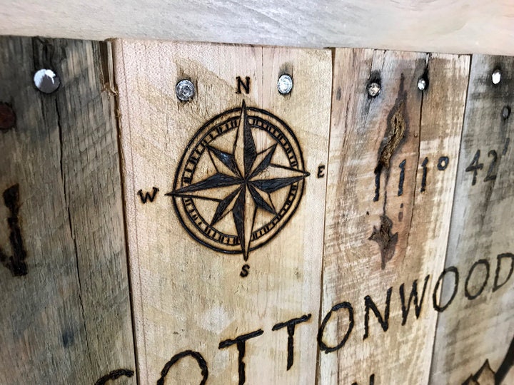 Wooden board with compass rose and 'Cottonwood' text on a rustic background
