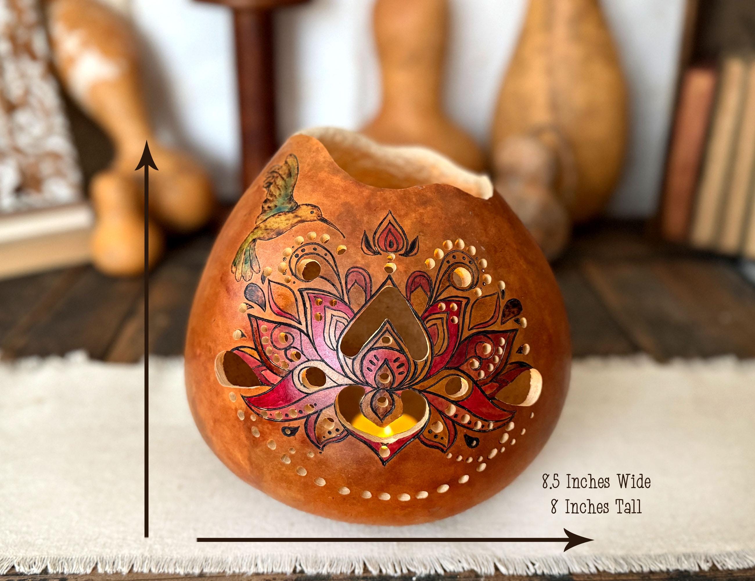 Decorative gourd with intricate designs on a white surface