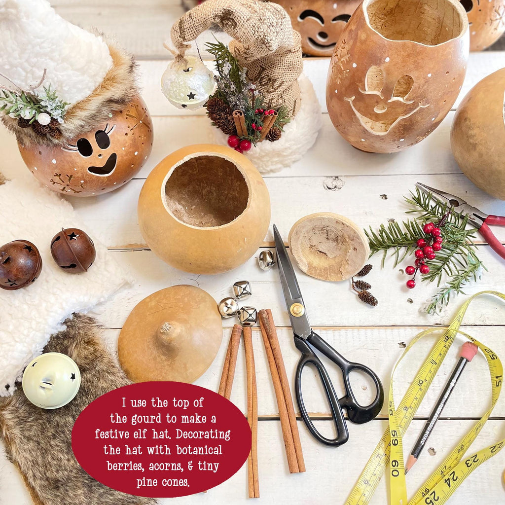 Decorative gourds with festive elements on a wooden surface with tools.
