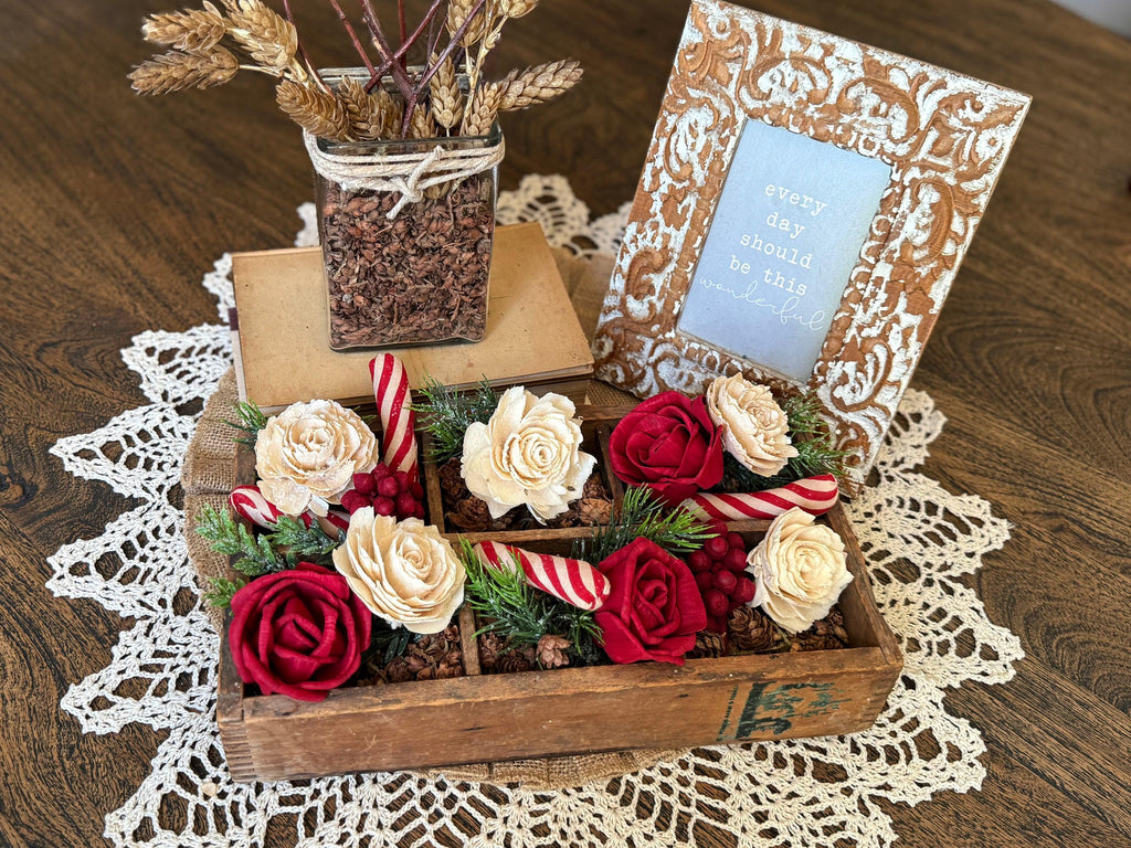 Decorative box with flowers and candy canes on a lace tablecloth