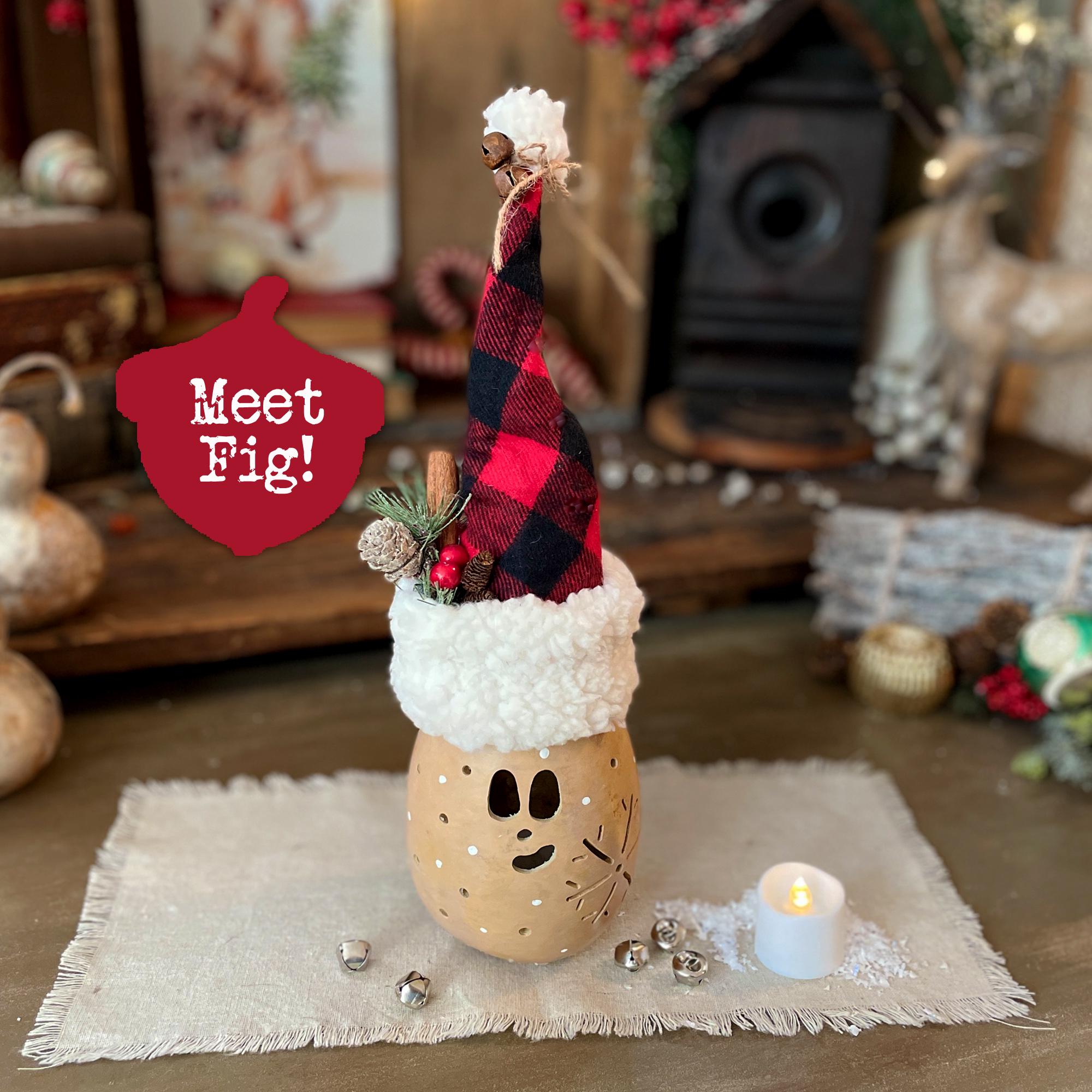 Decorative Christmas-themed figurine with plaid hat and candle on a rustic surface.