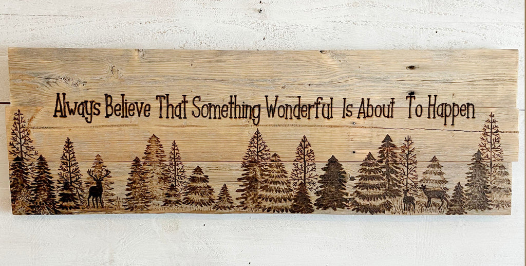 Wooden sign with nature design and motivational quote on a white wooden background, featuring the website 'www.boutiquebarn.