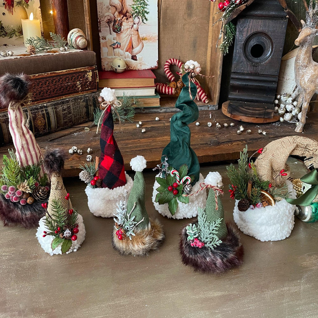 Decorative Christmas figures on a wooden surface with a rustic background.