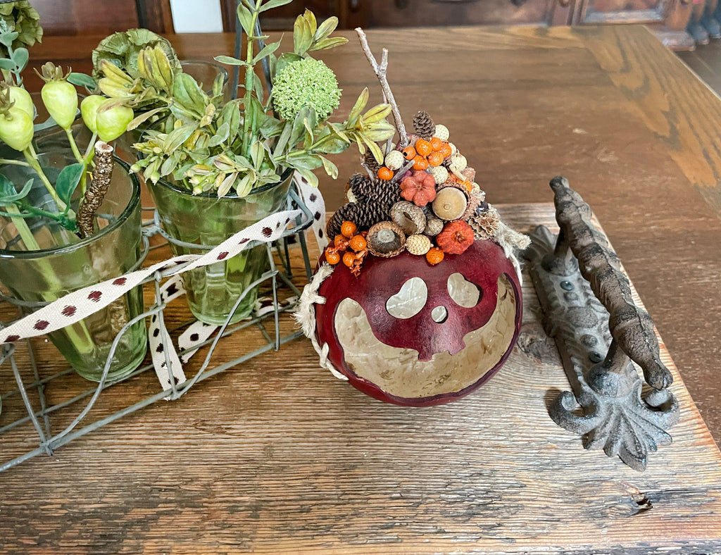 Decorative pumpkin with natural elements on a wooden surface