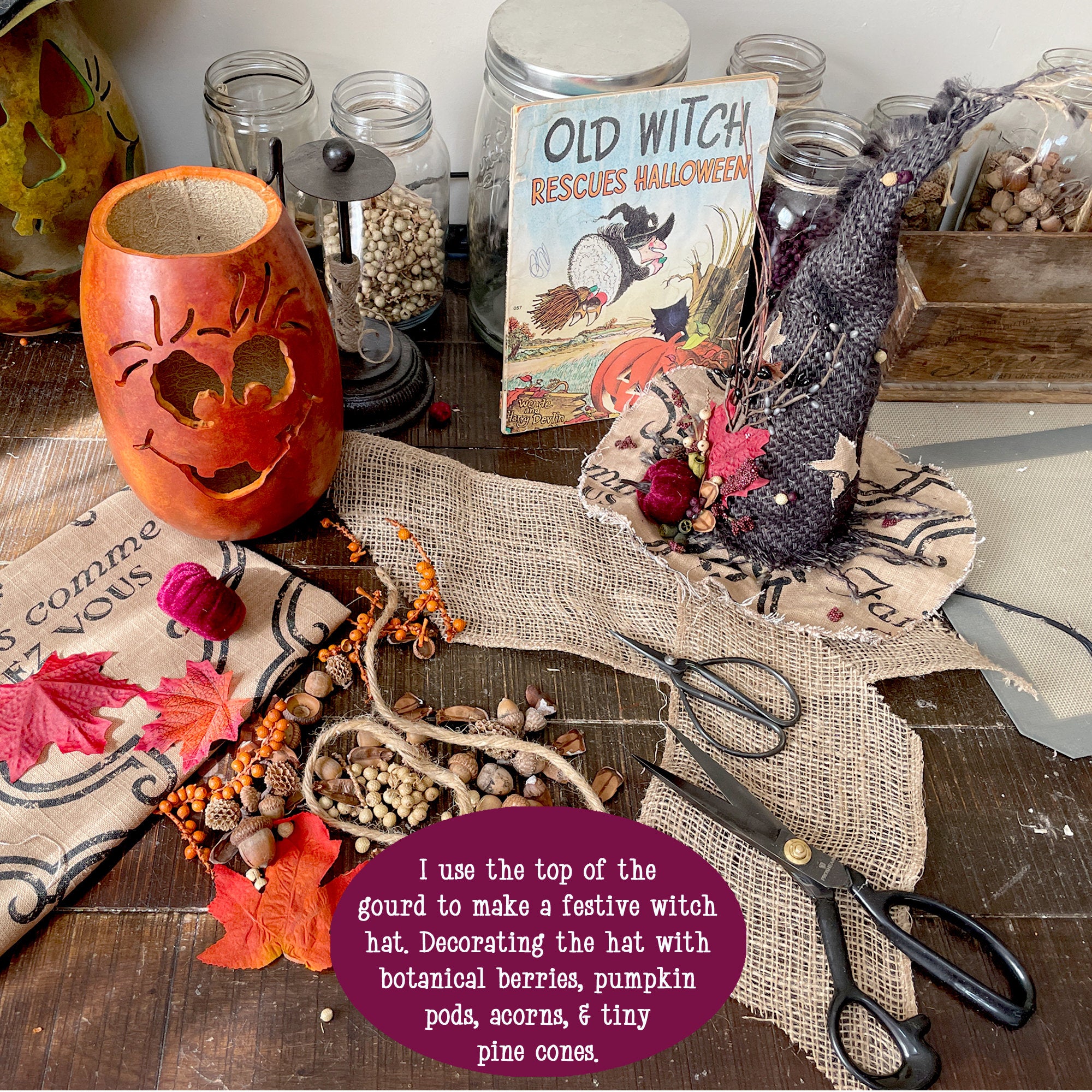 Halloween-themed decor with a carved gourd, book, and decorative items on a table.