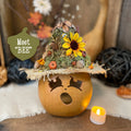 Decorative pumpkin with a small tree and sunflower on top, featuring the text 'Meet BEE'.