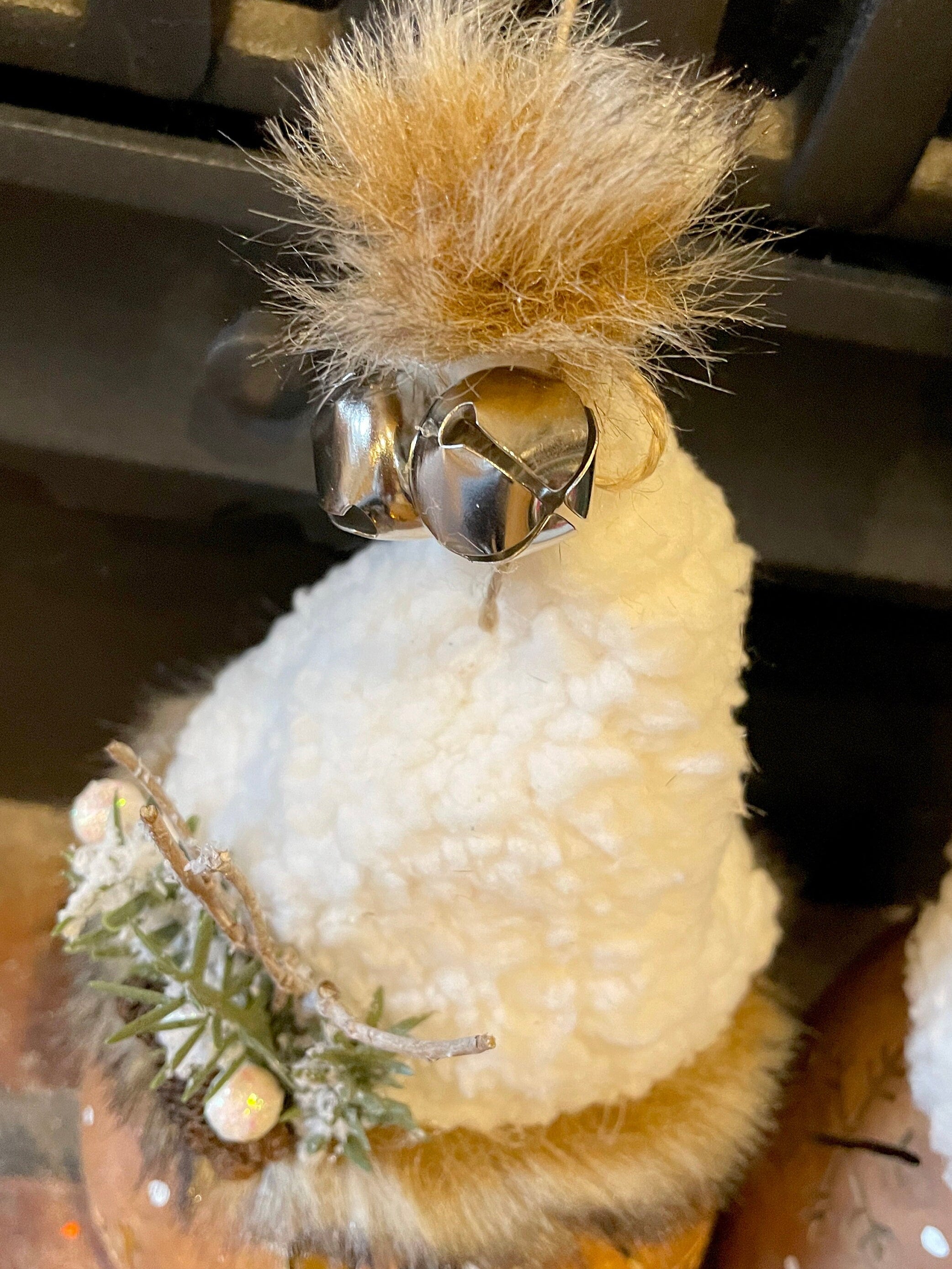Decorative chicken with fluffy feathers and a bell, featuring the website 'www.boutiquebarn.net'.