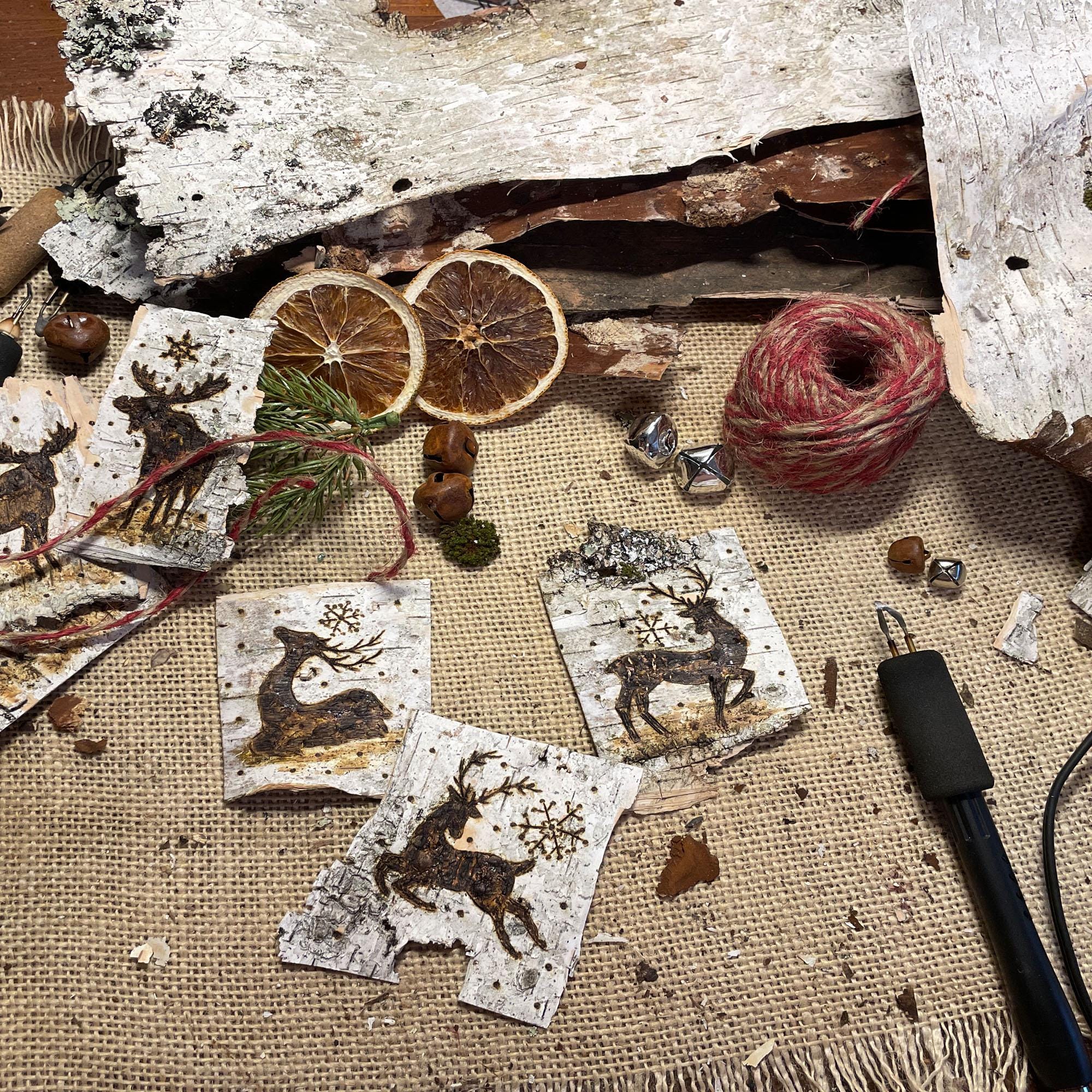 Decorative tags with reindeer designs on a rustic background with twine and natural elements.