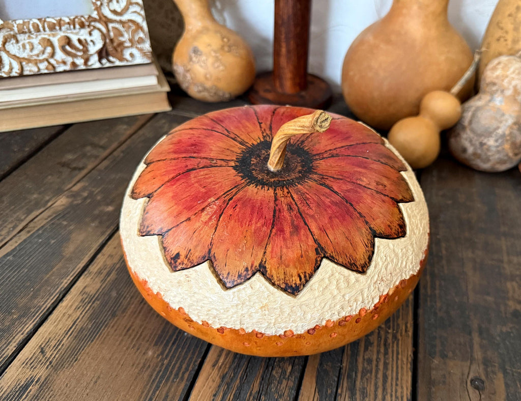 Decorative gourd bowl with lid. Lid us the shape of a sunflower. Gourd stem acts as handle to lid.