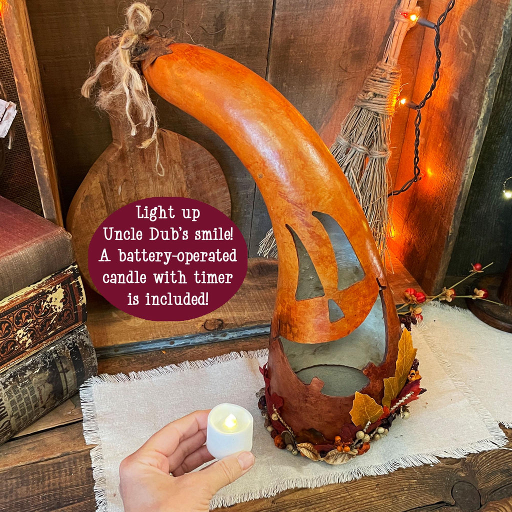 Decorative wooden lantern with a battery-operated candle on a rustic background