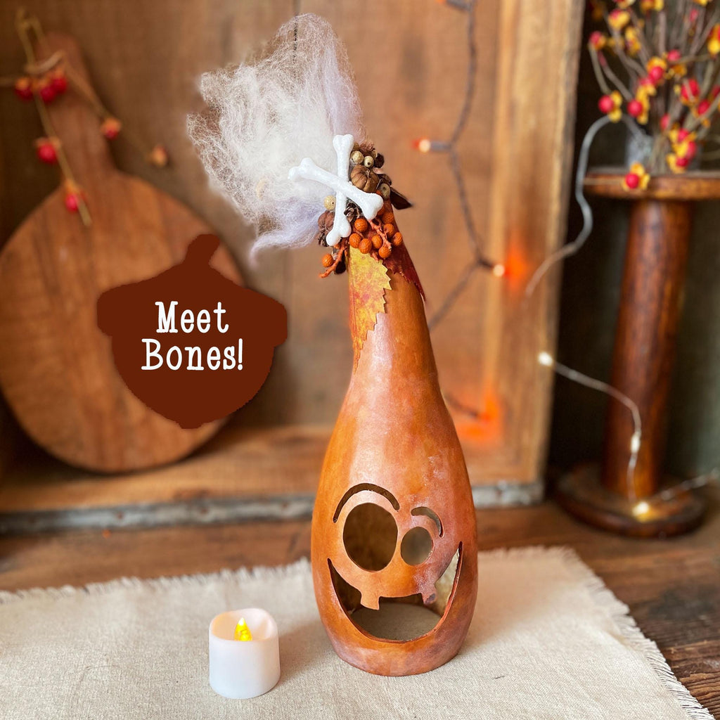 Decorative gourd with a ghost top on a rustic background