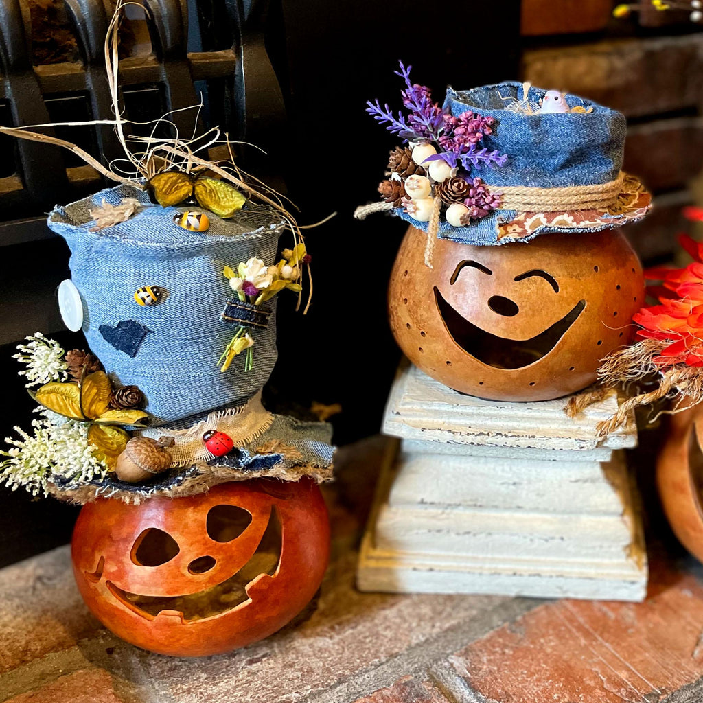 Decorative pumpkins with blue and brown hats on a stone surface