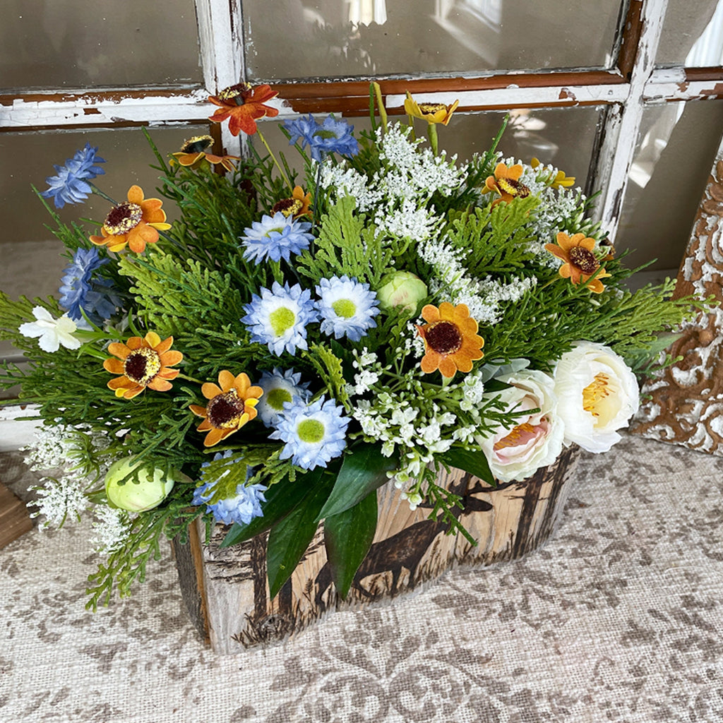 Bouquet of flowers in a wooden box with a rustic background