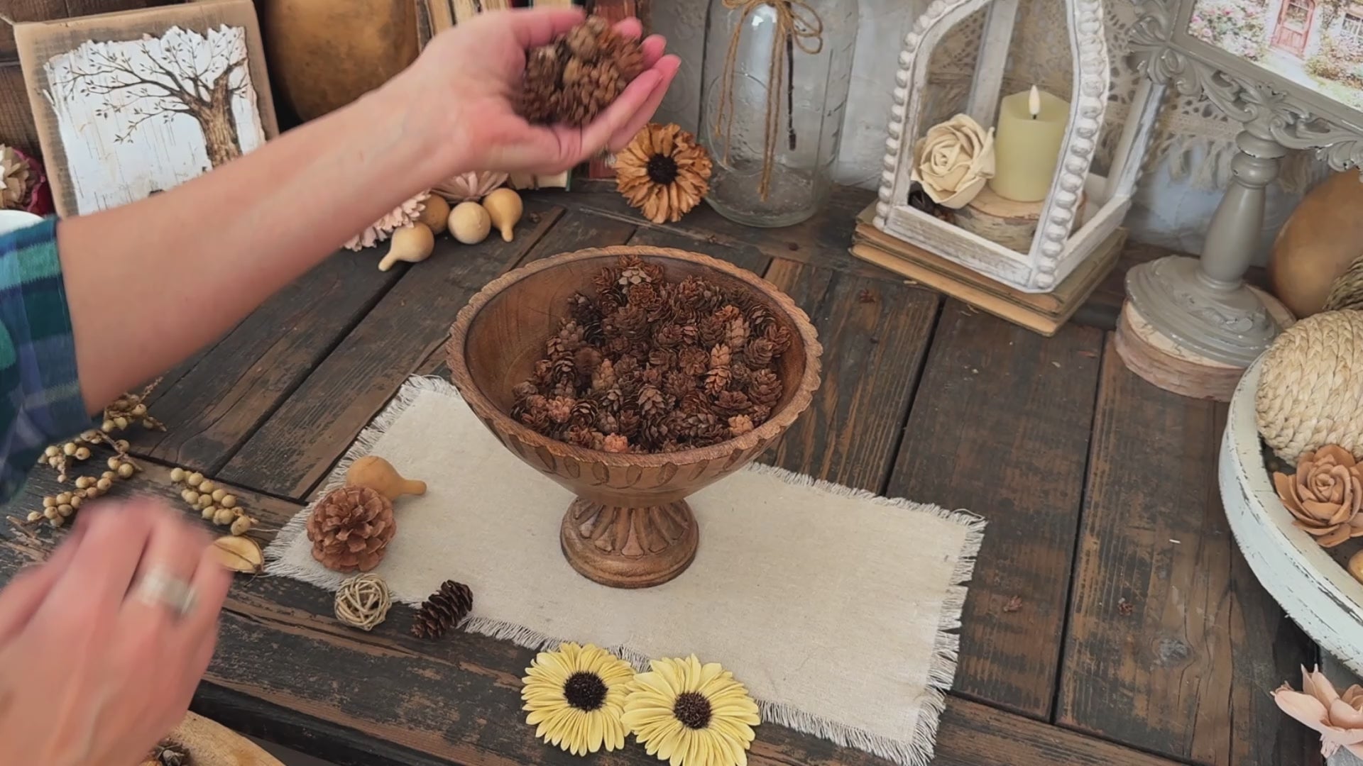 Video showing a wooden bowl botanical flower arrangement. 
