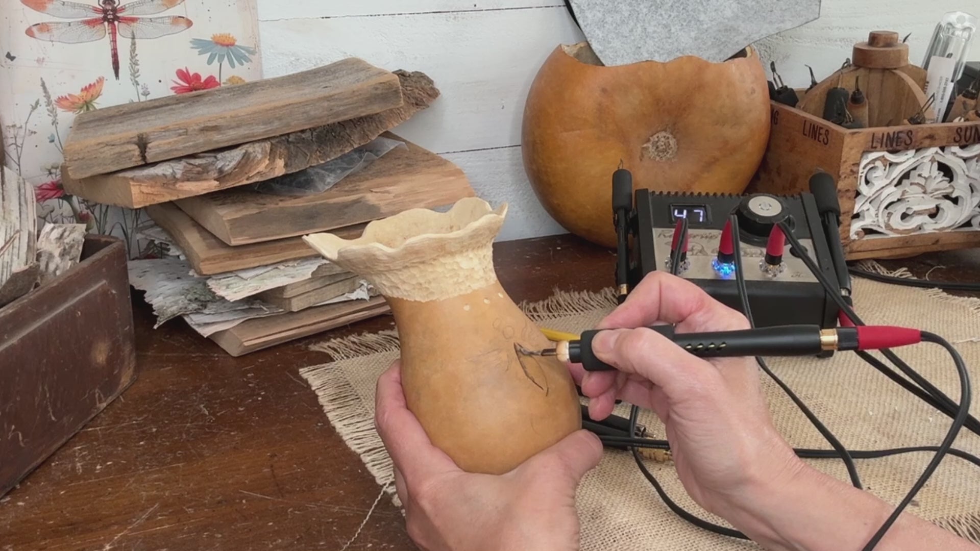 A video showing an angel burned onto the gourd surface.